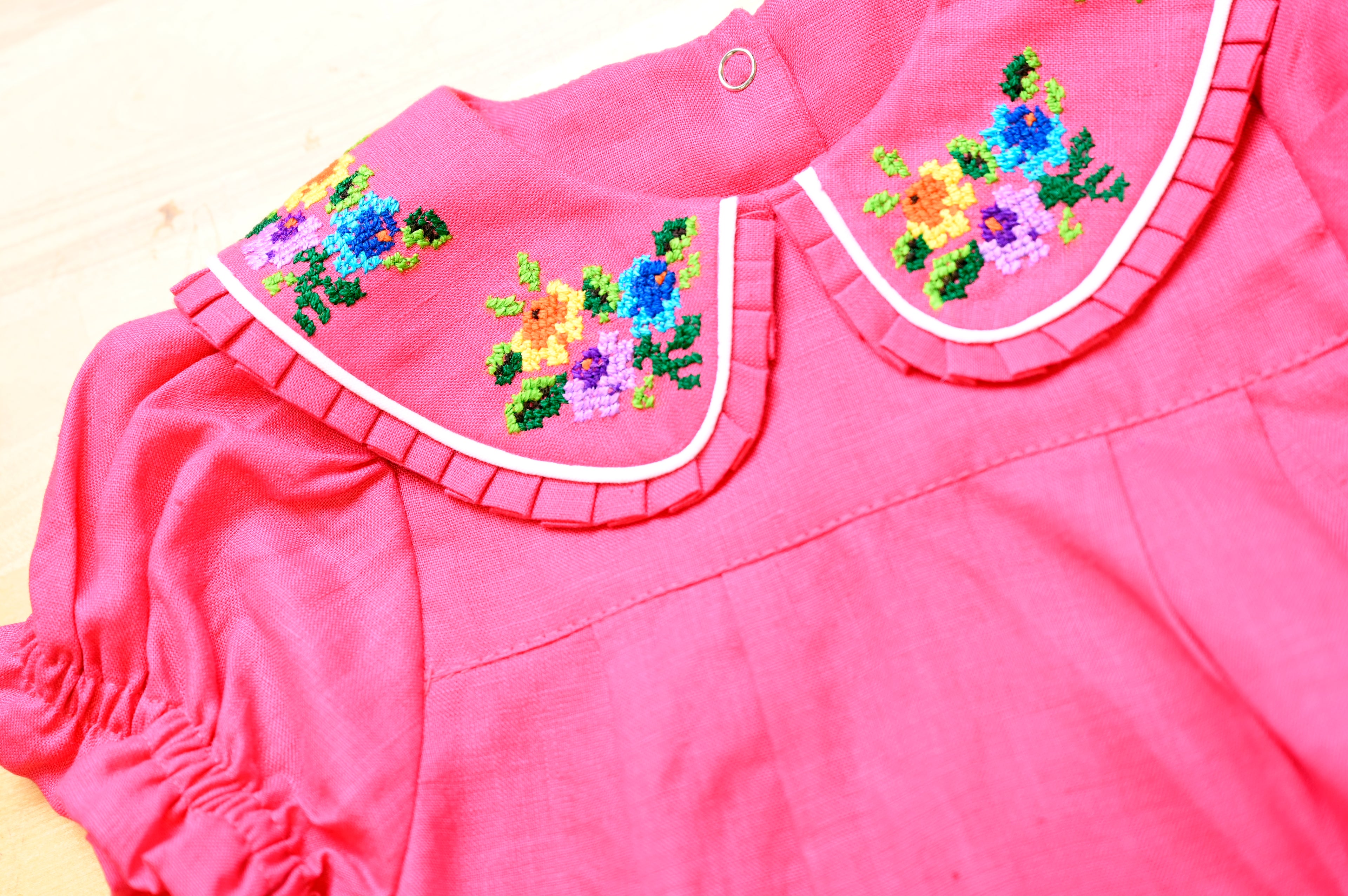 Mamilu Crafted from 100% natural linen and adorned with an artisan-embroidered
